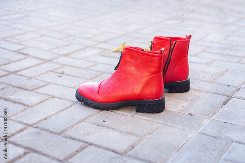 on the paving slabs in the fall is a pair of red women's shoes © Natalya