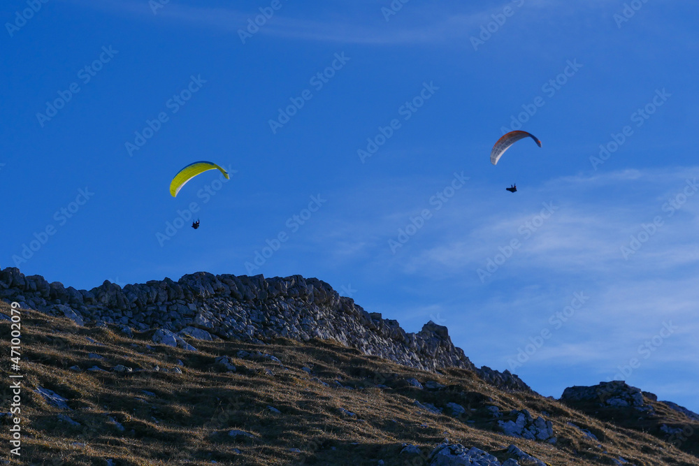 Paraglider flying over mountains in summer day in front of the mountain, High quality photo Paraglider flying over mountains in summer day in front of the mountain, High quality photo