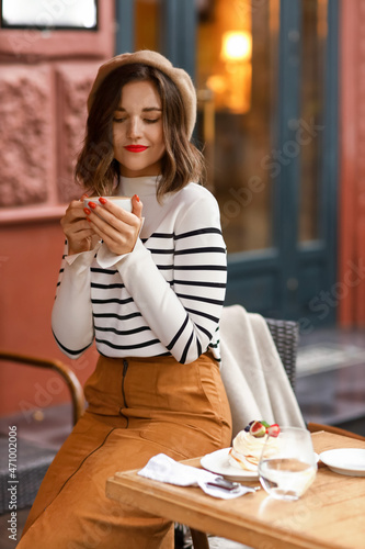 Beautiful woman with cup of...