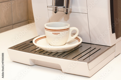 white cup of espresso in coffee machine