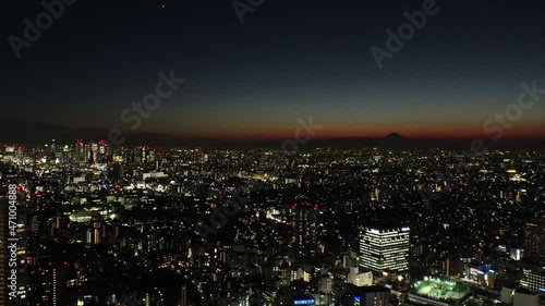 Wallpaper Mural TOKYO, JAPAN : Aerial high angle sunset CITYSCAPE of TOKYO and MOUNT FUJI. Golden sun sinking behind mountains. Japanese city life and nature concept. Long time lapse shot dusk to night. Torontodigital.ca