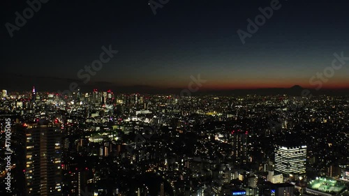 Wallpaper Mural TOKYO, JAPAN : Aerial high angle sunset CITYSCAPE of TOKYO and MOUNT FUJI. Golden sun sinking behind mountains. Japanese city life and nature concept. Long time lapse shot dusk to night. Torontodigital.ca