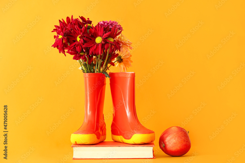 Rubber boots, flowers, book and apple on color background - obrazy, fototapety, plakaty 