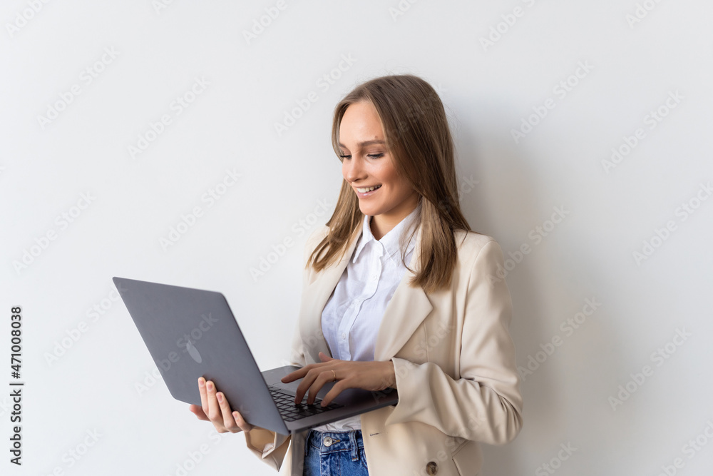 Portrait of young businesswoman holding laptop in the office isolated over white background Portrait of young businesswoman holding laptop in the office isolated over white background