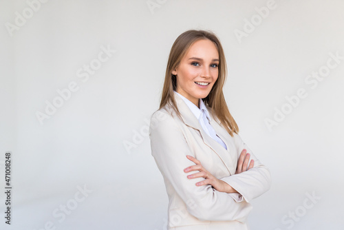 Smiling business woman with crossed arms isolated on white background.