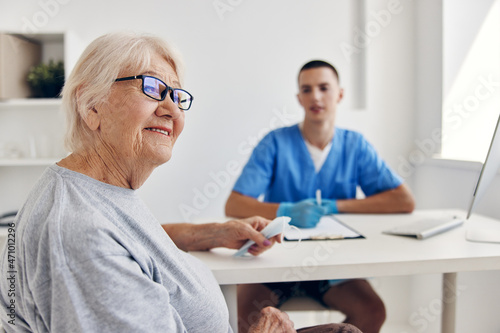 old woman talking to the doctor in the medical office