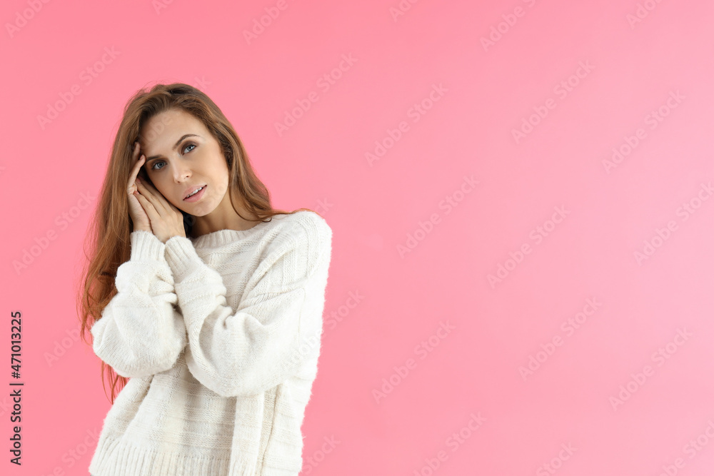 Attractive woman in sweater on pink background Attractive woman in sweater on pink background