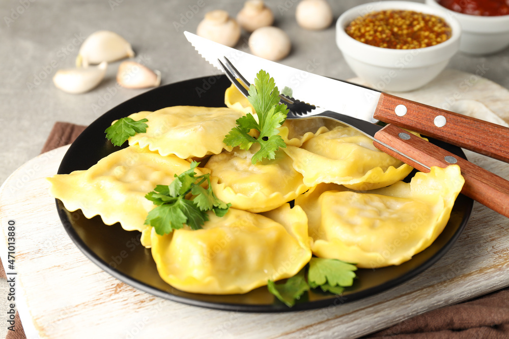 Delicious food concept with ravioli on gray background Delicious food concept with ravioli on gray background