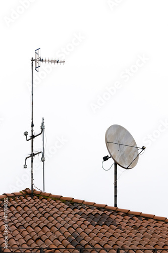technology antennas on roof with tiles that sends tv waves