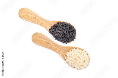 Black sesame seeds and white sesame seeds organic in wooden spoon on white background. Health food concept.