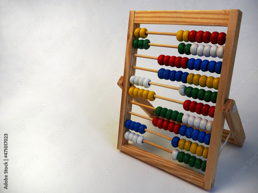 on the right, wooden children's abacus stand on a gray background, side view. preschool education for children on the right, wooden children's abacus stand on a gray background, side view. preschool education for children