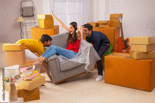 Adult boys and girl having fun during house shifting