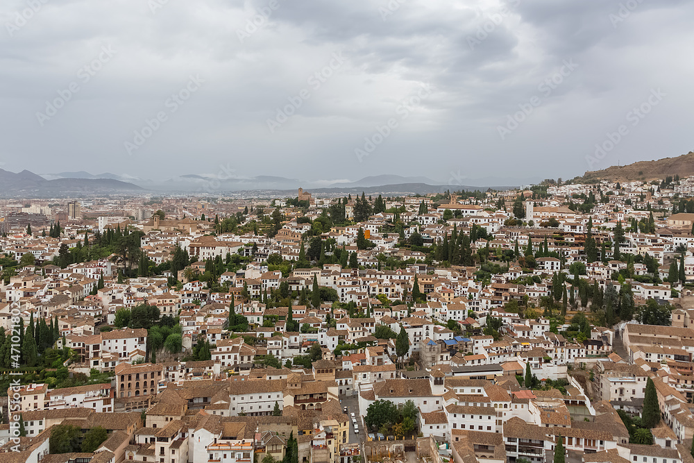 Aerial view at the main Granada cityscape, view from the Alhambra citadel palace lookout, architecture buildings and horizon, Spain