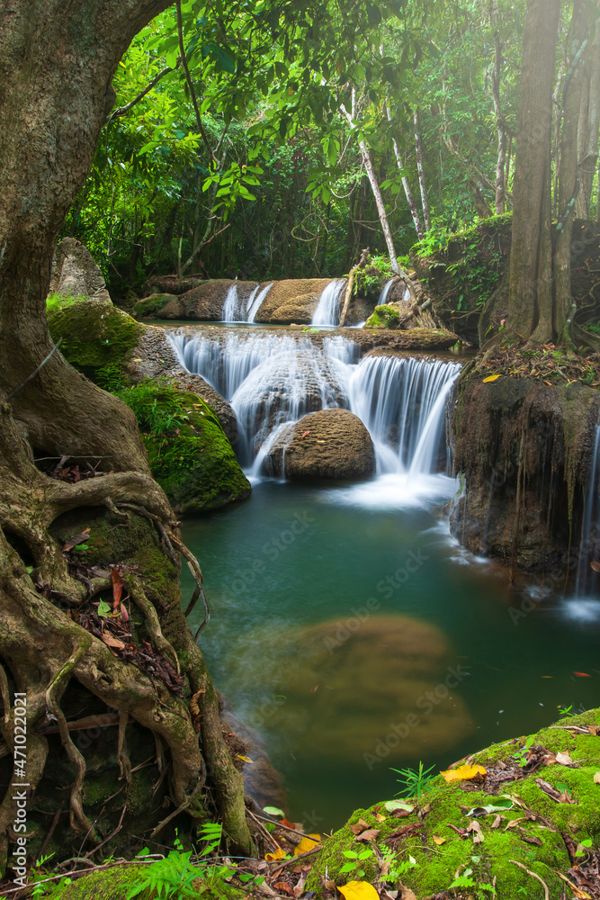 Naklejka premium Landscape of pure tropical waterfall on rainy morning.