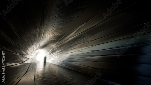 Concept or conceptual dark tunnel with a bright light at the end or exit as metaphor to success, faith, future or hope, a black silhouette of walking man to new opportunity or freedom 3d illustration