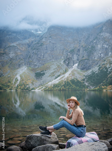 Young woman on a hiking trip sitting on a rock © Olena Rudo