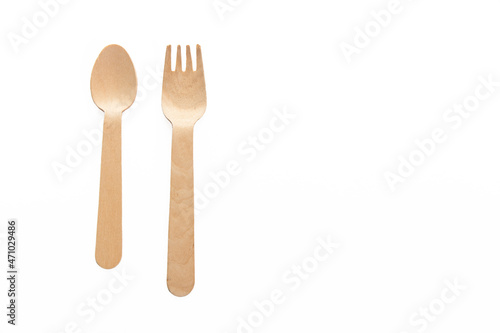 wooden spoon and folks isolated on the white background ready to cook and taste with the ingredients of your choice. Place for text. Copy space