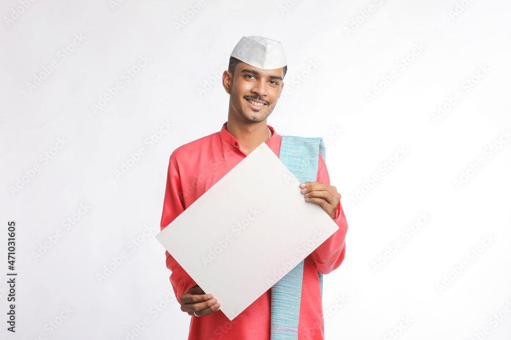 Young indian farmer holding white card board on white background. Young indian farmer holding white card board on white background.