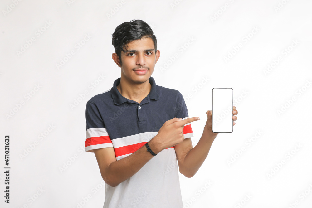 Young indian college student showing smartphone Screen on white background. Young indian college student showing smartphone Screen on white background.