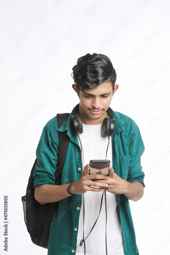 young man using smartphone and headphone accessory. young man using smartphone and headphone accessory.