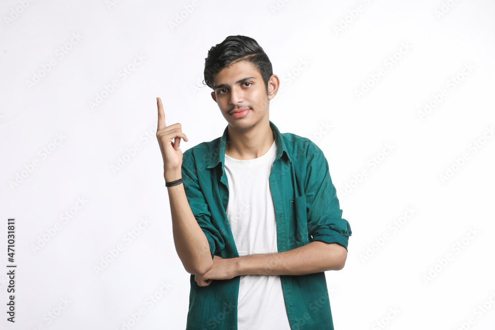 Young indian man giving expression with hand over white background. Young indian man giving expression with hand over white background.