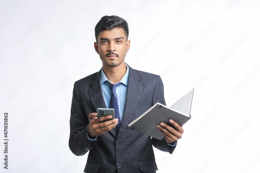 Young indian business man using smartphone on white background.