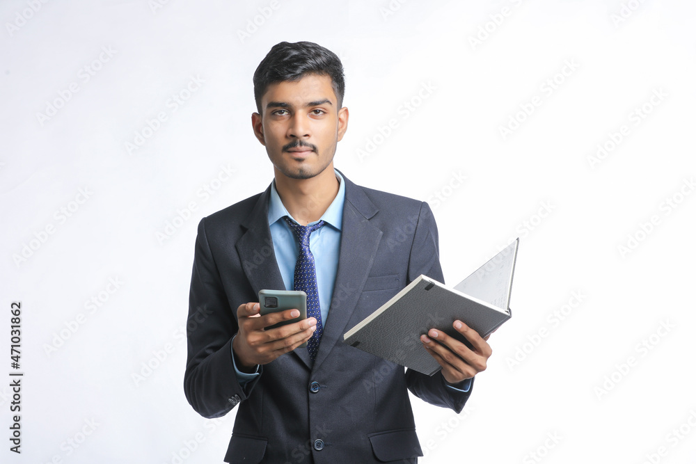 Young indian business man using smartphone on white background. Young indian business man using smartphone on white background.
