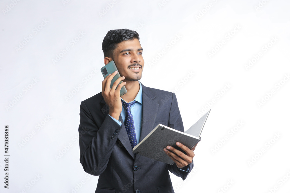 Successful Young indian business man talking on smartphone over white background Successful Young indian business man talking on smartphone over white background