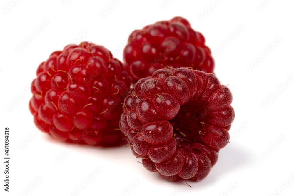 Raspberries. Three ripe raspberries isolated on a white background close-up. Raspberries. Three ripe raspberries isolated on a white background close-up.
