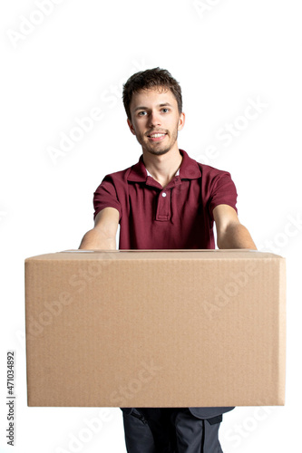 Smiling delivery man holding pile of cardboard boxes on a white background .