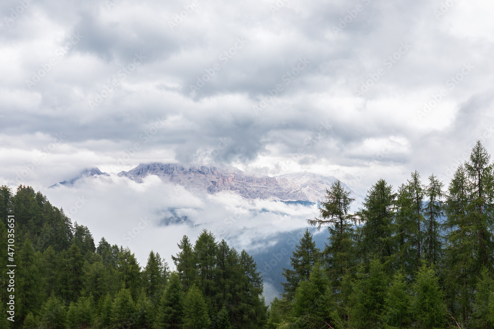 View of the Italian Dolomites covered with fog after rain