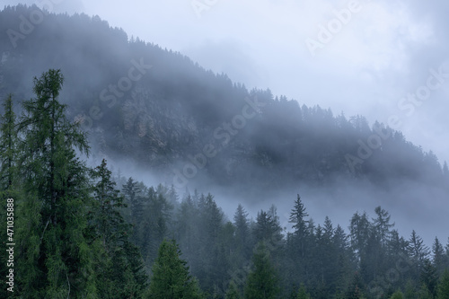 The mountain slopes of the Italian Dolomites covered with dense fog