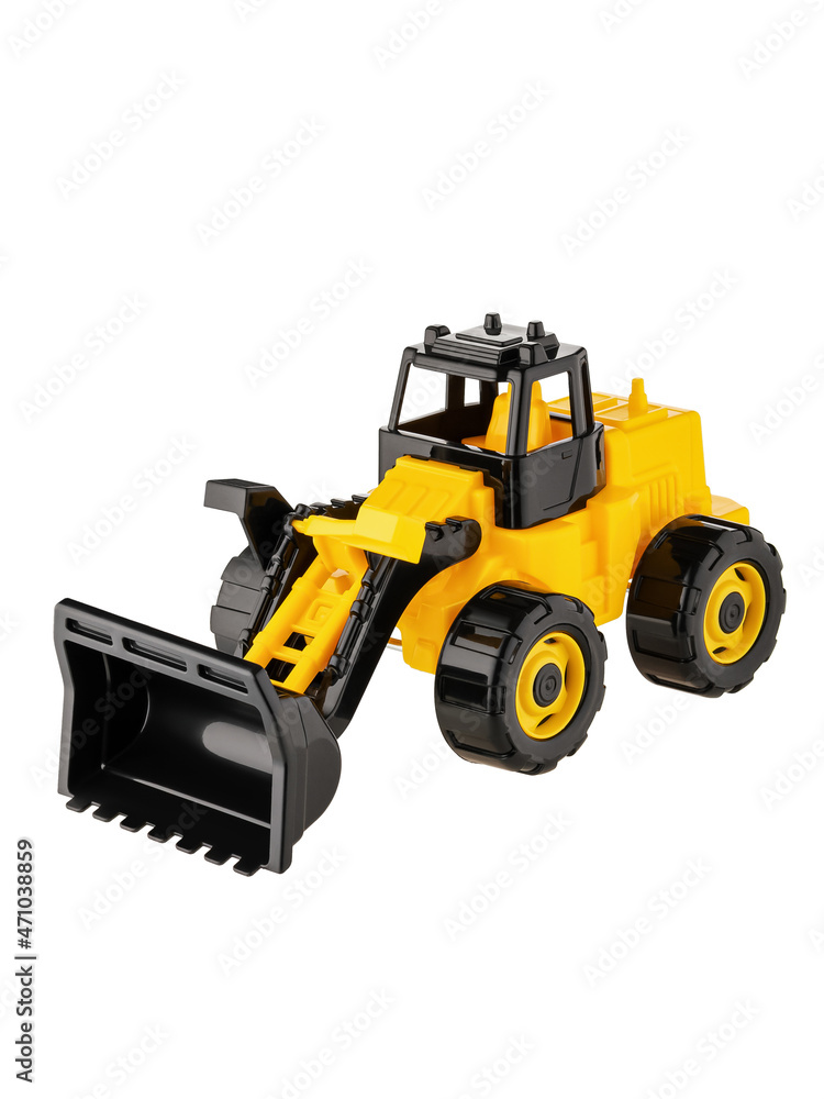 A toy tractor in black and yellow with a bucket lowered down is isolated on a white background. Side view. Perfect retouching. A toy tractor in black and yellow with a bucket lowered down is isolated on a white background. Side view. Perfect retouching.