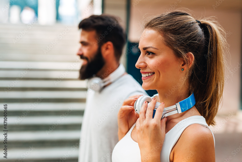 Naklejka premium Happy runner couple exercising outside as part of healthy lifestyle. People sport running concept