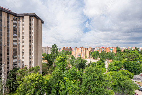 Views of several residential buildings in the city with lots of trees around