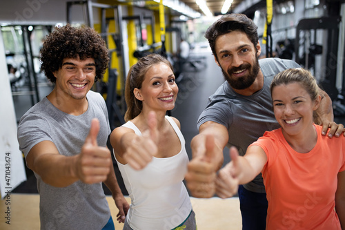 Portrait of happy fit group of people working out in gym together