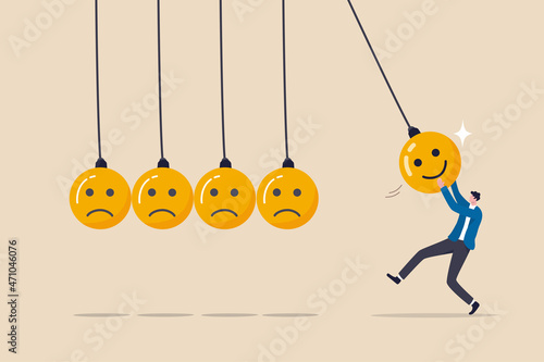 Optimistic, happiness or positive thinking inspire other people happy, emotional intelligence or balance between happiness and sadness, man holding smile face pendulum ball to hit other sad faces. photo
