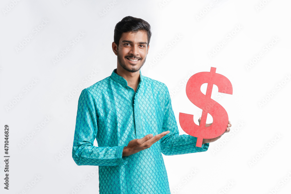 Young indian man holding dollar symbol in hand on white background. Young indian man holding dollar symbol in hand on white background.