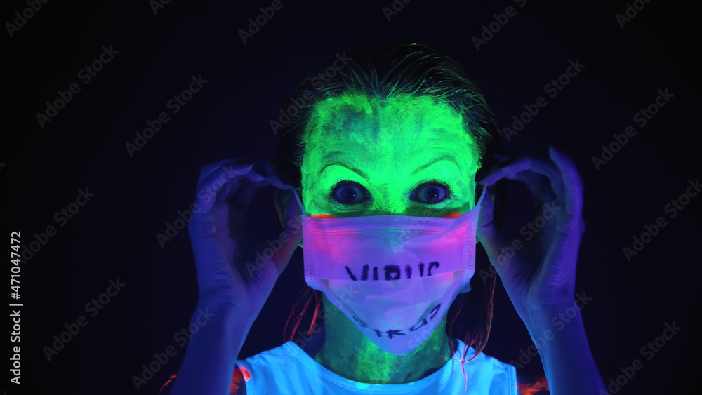 Photo of undressing mask woman with scary painted face Photo of undressing mask woman with scary painted face
