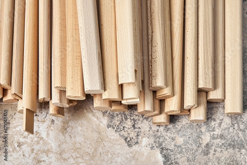 Huge pile of wooden bars made of solid beechwood material lies in contemporary carpentry workshop closeup upper view. Production of wooden swedish ladder photo