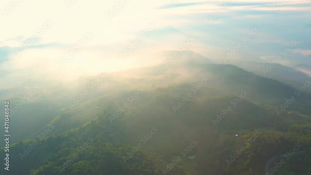 4K Flying through the clouds above mountain tops. Tropical forest with smoke and fog.
4K Flying through the clouds above mountain tops. Tropical forest with smoke and fog.