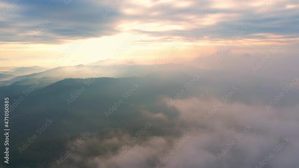 4K Flying through the clouds above mountain tops. Tropical forest with smoke and fog.
4K Flying through the clouds above mountain tops. Tropical forest with smoke and fog.