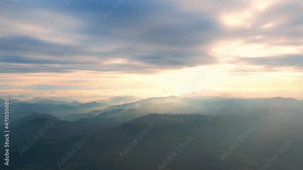 4K Flying through the clouds above mountain tops. Tropical forest with smoke and fog.
4K Flying through the clouds above mountain tops. Tropical forest with smoke and fog.