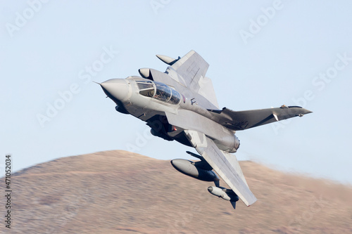 jet fighter, military aircraft flying low level in the United Kingdom. Military aeroplane on a combat training mission photo