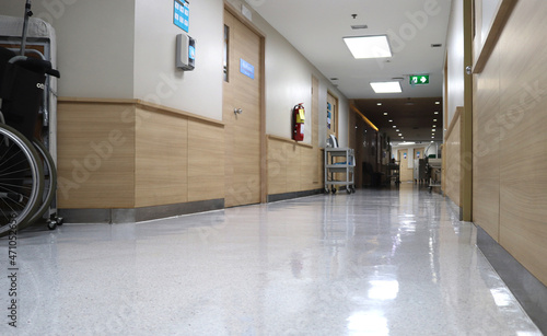 Empty wheelchair in hospital corridor. Chair for transporting patients around hospital. health and care of quality of life concept.