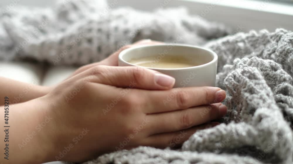 Cozy home with cup of coffee and a book. Hygge style. Mug of black coffee wrapped in warm scarf on wooden board. Top view, vintage style, Still life. Cozy home with cup of coffee and a book. Hygge style. Mug of black coffee wrapped in warm scarf on wooden board. Top view, vintage style, Still life.