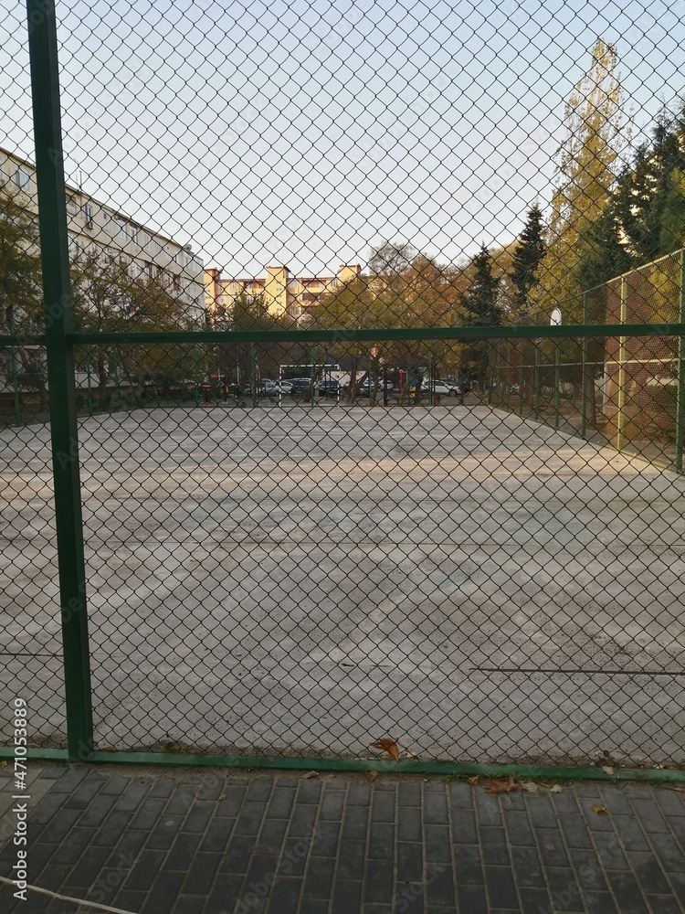 Children's football and basketball field covered with a net