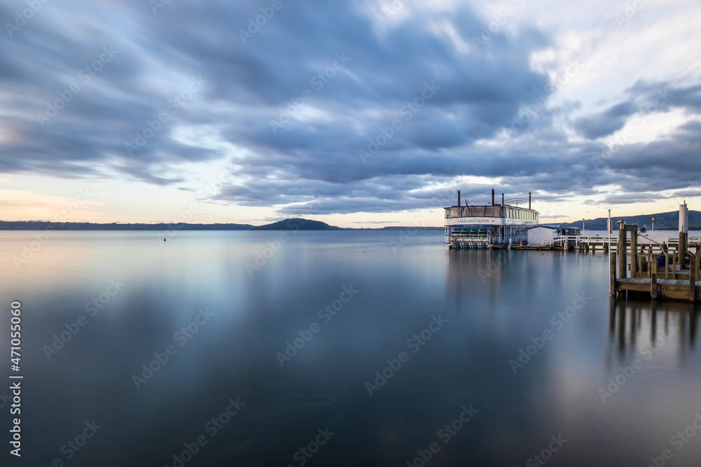 View of Owhatiura Bay with a restaurant in the lake at sunset with Mokoia island in background, Rotorua, New Zealand. View of Owhatiura Bay with a restaurant in the lake at sunset with Mokoia island in background, Rotorua, New Zealand.
