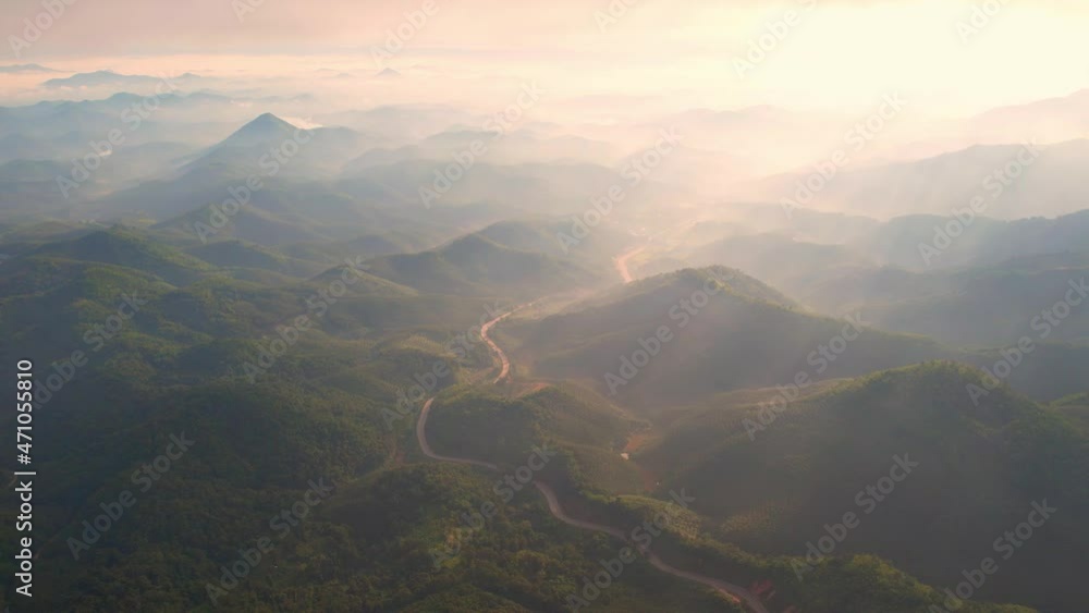4K aerial view from a drone flying over the valley, fog and sun rays in the morning.
4K aerial view from a drone flying over the valley, fog and sun rays in the morning.