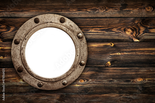 Close-up of an old rusty closed empty porthole window. Old rich wood grain texture background with knots. photo